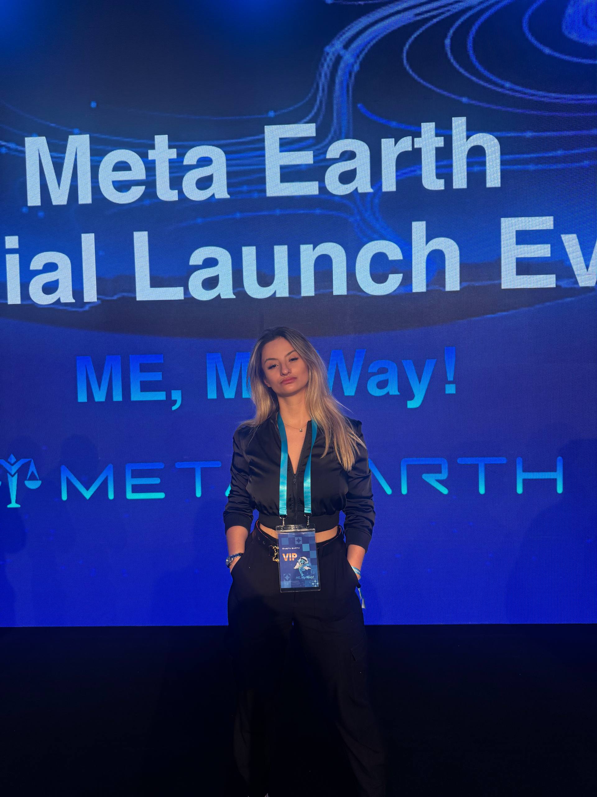 Jana at Meta Earth VIP launch with dramatic blue backdrop